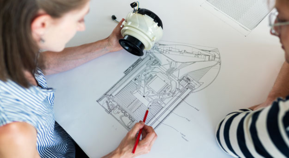 Engineers reviewing a technical product drawing